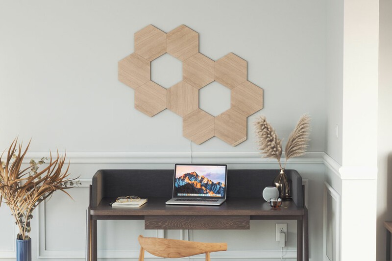 Nanoleaf Elements light tiles installed above a desk. 